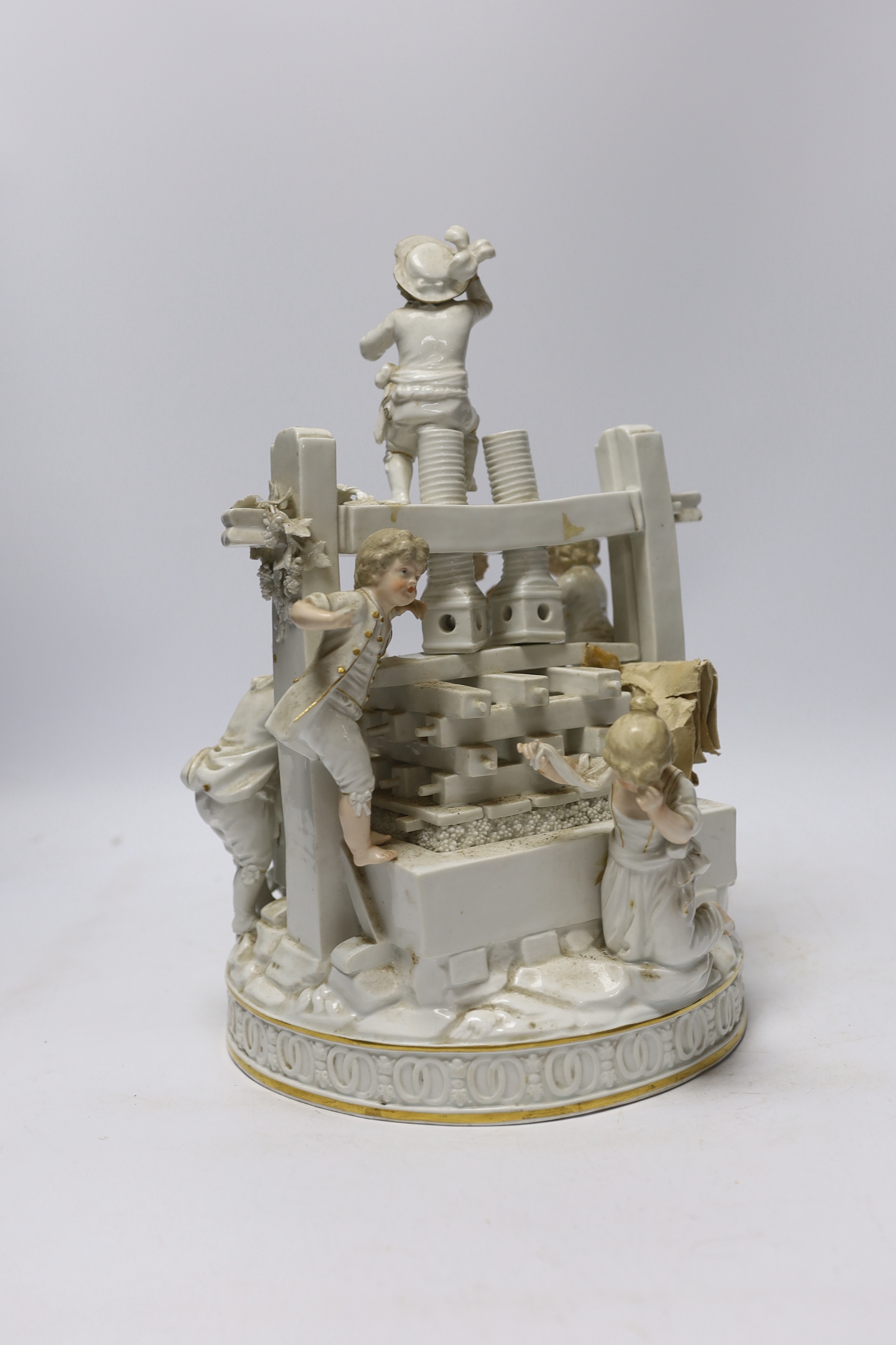 A late 19th century German white glazed porcelain group, ‘’The Wine Press’’, after a Meissen original by Johann Carl Schonheit, 33cm